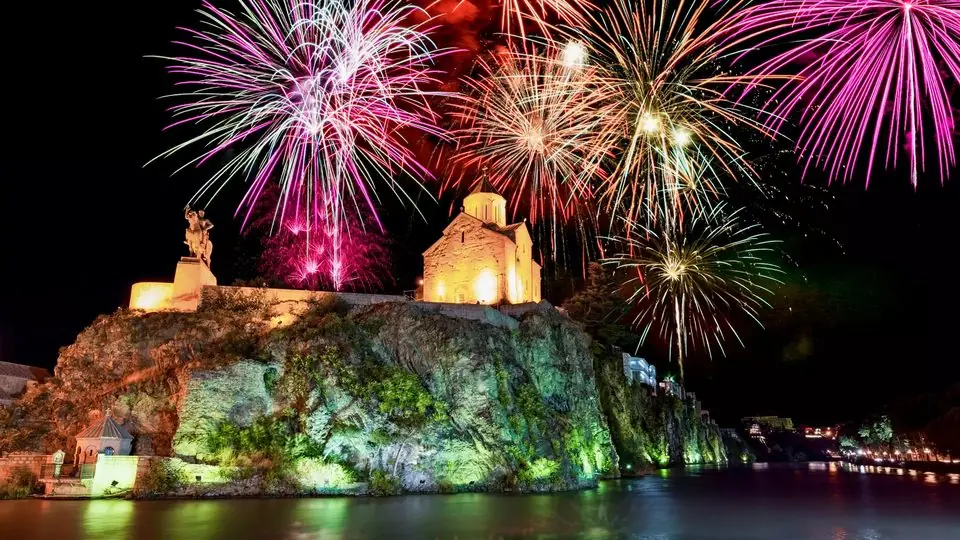 New Year fireworks over the floodlit Metekhi church and the King Vakhtang Gorgasali statue on the cliff above the Mtkvari in Tbilisi