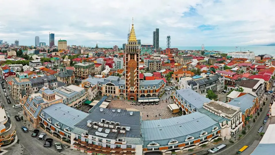 Aerial view of Batumi Piazza with surrounding streets, parked cars and the city skyline